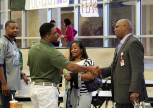 New Principal Carlos Meekins is greeted by staff during his first meeting with them prior to start of school. (John Hunt photo)
